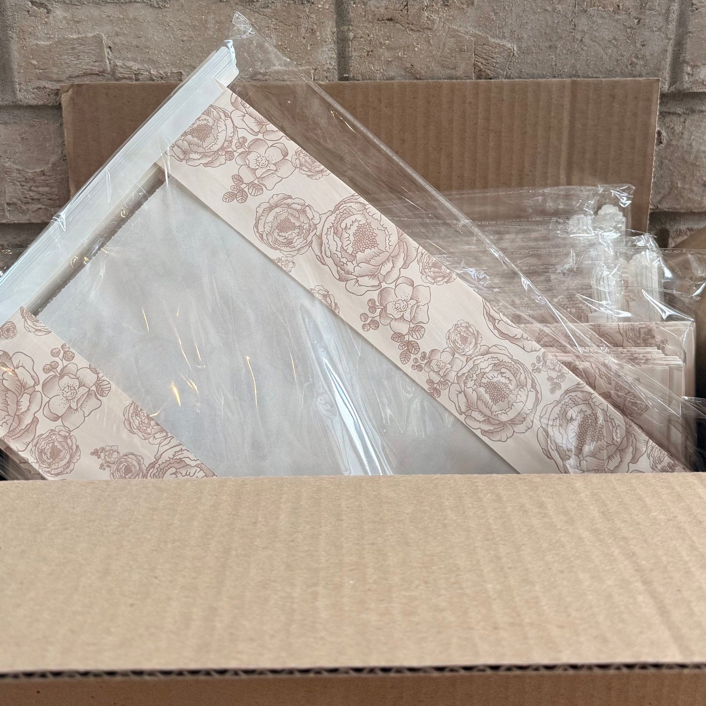 Cardboard boxes with decorative items against a brick wall