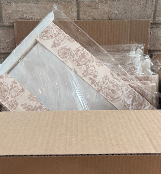 Cardboard boxes with decorative items against a brick wall